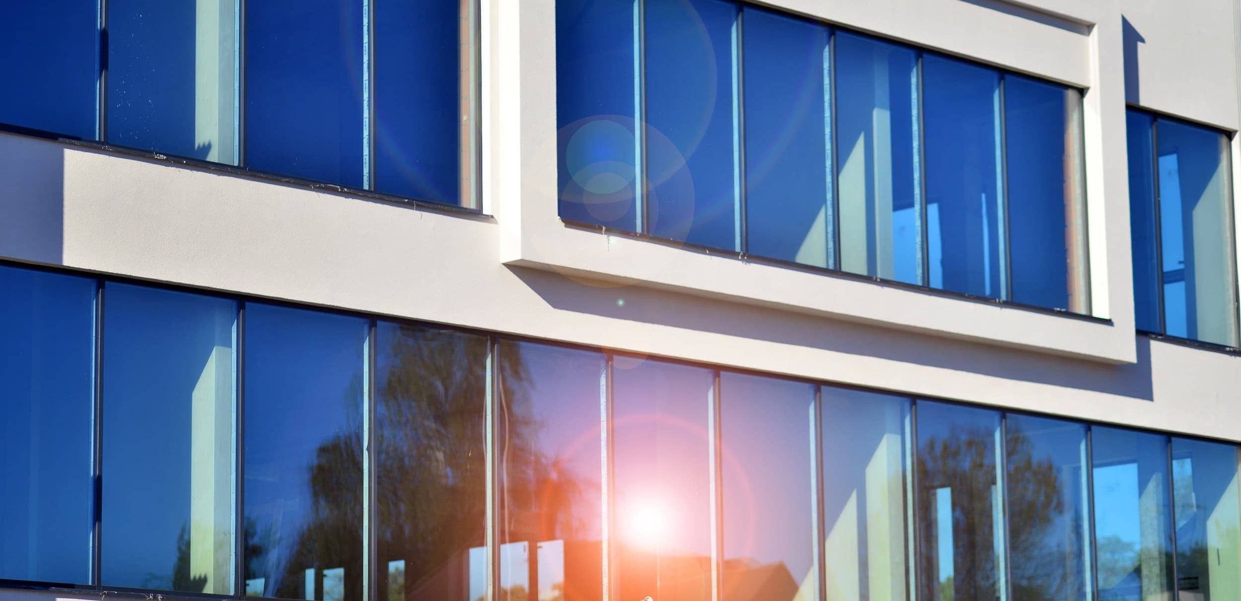full building with sun shining through tinted windows