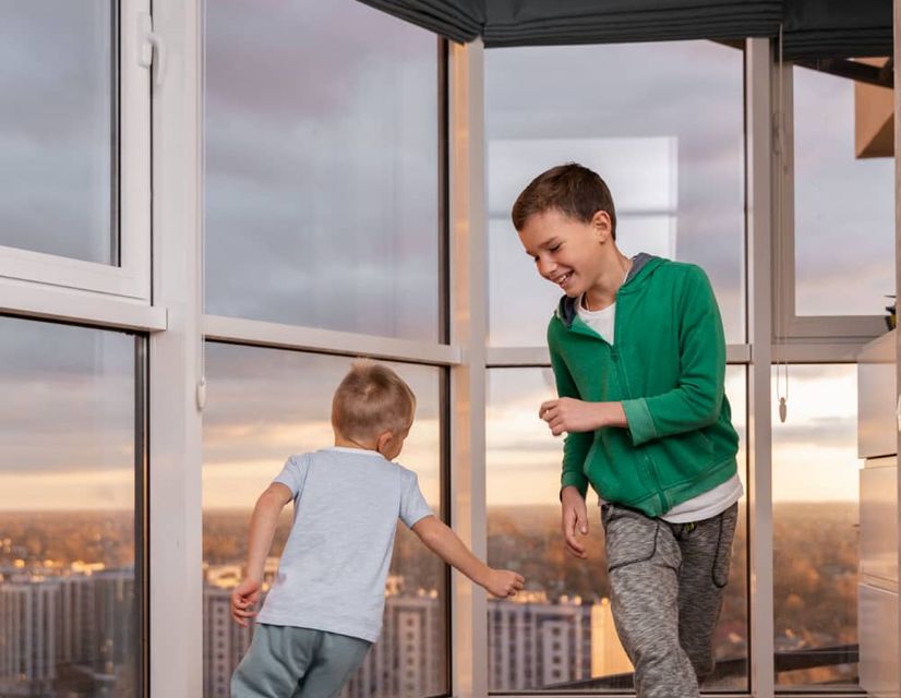 kids in front of residential tinted windows